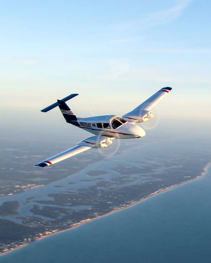 an airplane flying over the ocean and land