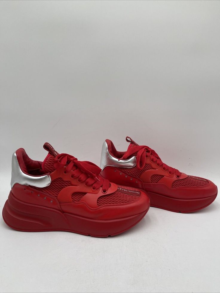 -Light creases on upper -Bottoms have sharpie stains Elevate your sneaker game with these Alexander McQueen Oversized Runner Sneakers in a bold red colorway. Made for men, these athletic shoes are perfect for those who want to add both style and comfort to their wardrobe. Featuring a brand known for their impeccable design, these sneakers are made for the fashion-forward. These sneakers come in a size 41 for both US and EU shoe sizes, and are designed as a sleek, modern, and oversized runner. With a brand and model name that speaks for itself, these Alexander McQueen sneakers are sure to become a staple in any sneakerhead's collection. D2 High-top Running Shoes With Perforations For Streetwear, Sporty Lace-up Sneakers With Red Sole, Red Lace-up Running Shoes For Jogging, University Red Low-top Sneakers With Rubber Sole, Low-top Sneakers With Red Sole, Dynamic High-top Sneakers With Perforations, Low-top Chunky Sneakers With Perforations For Streetwear, Red Dynamic Mesh Running Shoes, Dynamic Red Mesh Running Shoes