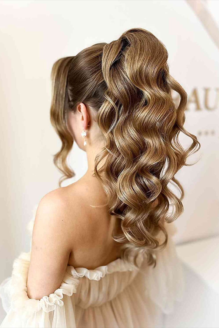 Chic hairstyle with a high ponytail featuring voluminous waves High Pony Hairstyles For Prom, Fancy Curled Ponytail, Ponytail Waves Hairstyles, Curls In A Ponytail, High Fancy Ponytail, High Ponytail Hairstyles With Curls, Deb Hairstyles Ponytail, Ponytail Curls Hairstyles, Curls In Ponytail