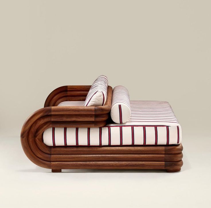 a bed made out of wood and white sheets with red stripes on the pillow covers