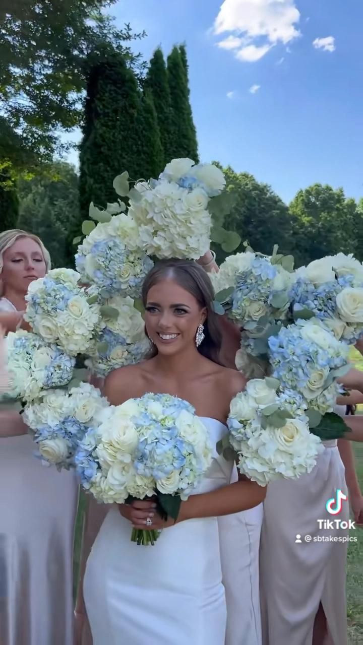 the bridesmaids are holding their bouquets together