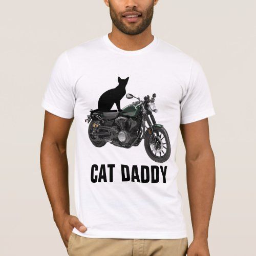 a man wearing a white t - shirt with a black cat sitting on a motorcycle