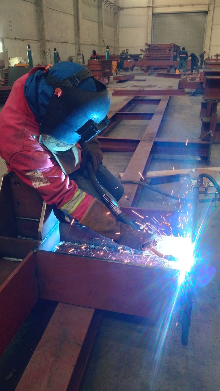 welder working on an item in a factory