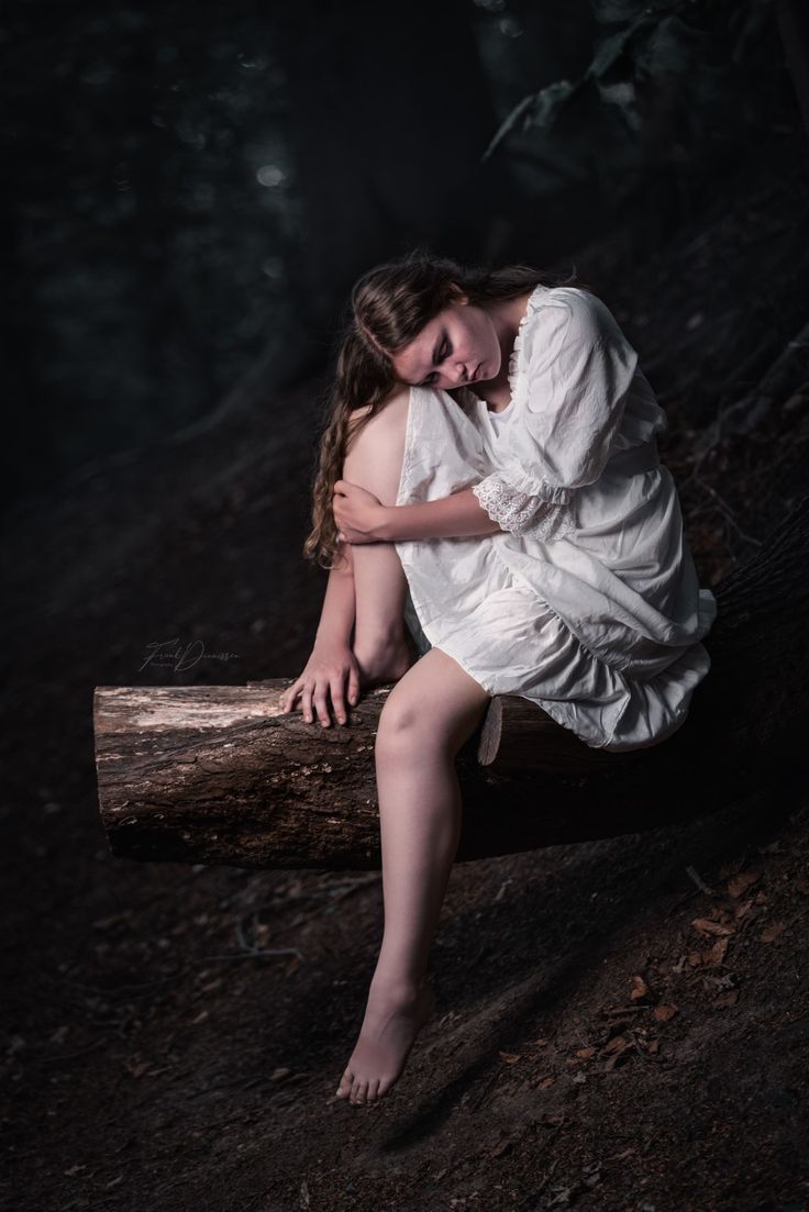 Girl sitting on a tree in the forest wearing a white sleepinggown Melancholy Poses Reference, Person Sitting With Legs Dangling, Sitting On Tree Pose, Dramatic Sitting Pose, Sitting In A Dress Reference, Sitting Poses Dress, Girl Lay Down, Sitting Dress Pose, Dress Sitting Reference