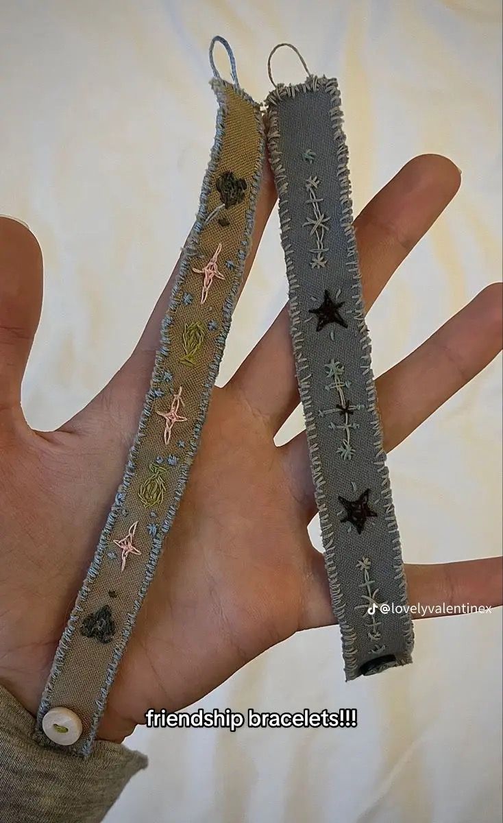 two handmade bracelets are held in the palm