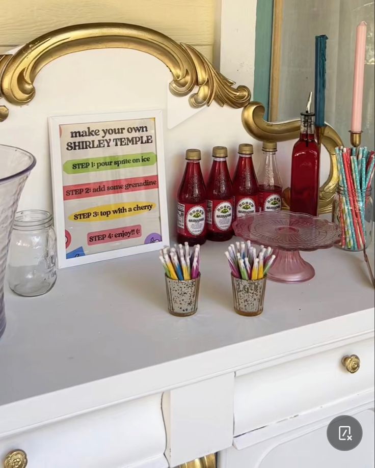 a white dresser topped with lots of different types of pens and pencils on top of it