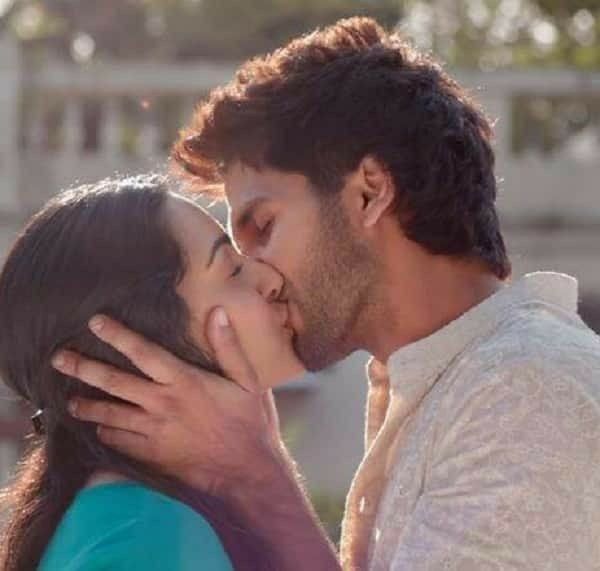 a man kissing a woman on the cheek