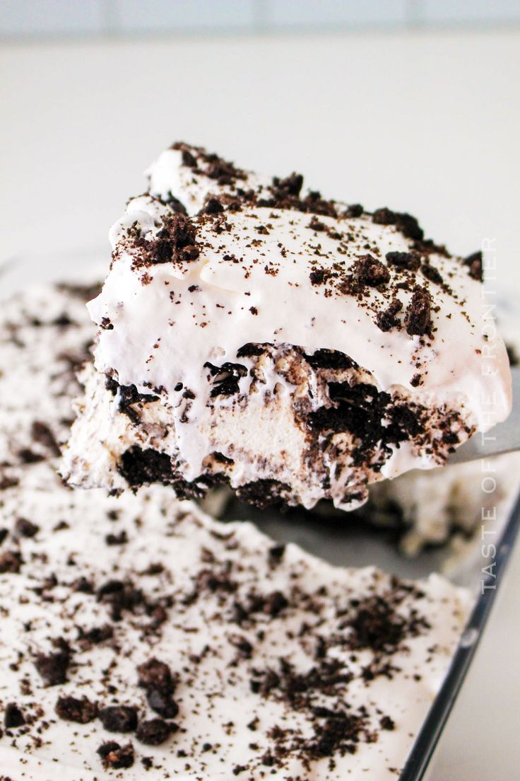 a close up of a piece of cake on a plate with ice cream and oreo