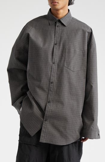 An oversized shirt is nothing new in the Balenciaga pantheon, but the twist here is that it's more of a jacket masquerading as a shirt (and no actual twist). What appear to be a proper button placket and button cuffs are camouflage for snap closures, bringing stealth jacket function to the voluminous cotton-poplin style. 29" length (size medium) Front snap closure Spread collar Long sleeves with snap cuffs Dropped shoulders Chest patch pocket Curved hem 100% cotton Dry clean Made in Italy Design Oversized Gray Long Sleeve Shirt, Oversized Long Sleeve Shirt In Gray, Classic Oversized Winter Shirt, Classic Oversized Shirt For Winter, Gray Shirt For Fall Streetwear, Oversize Shirt, Nothing New, Italy Design, Oversized Shirt