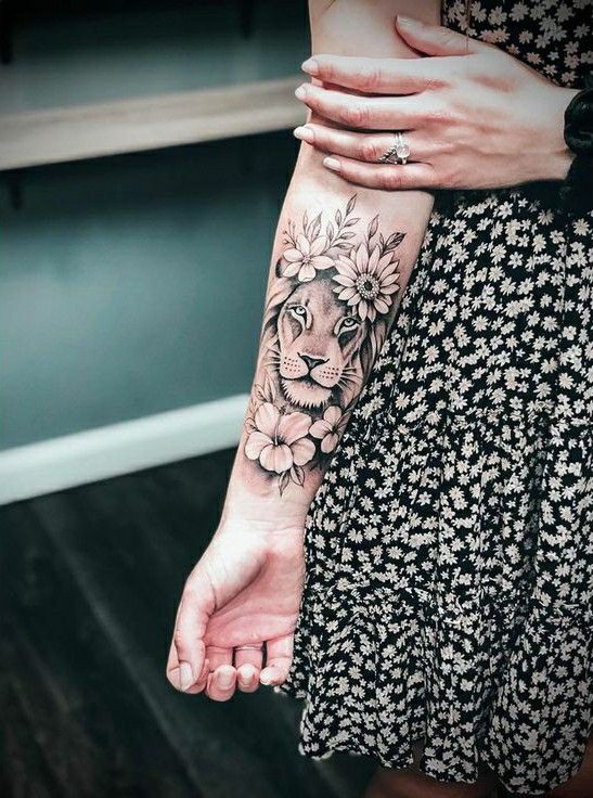 a woman with a lion tattoo on her arm