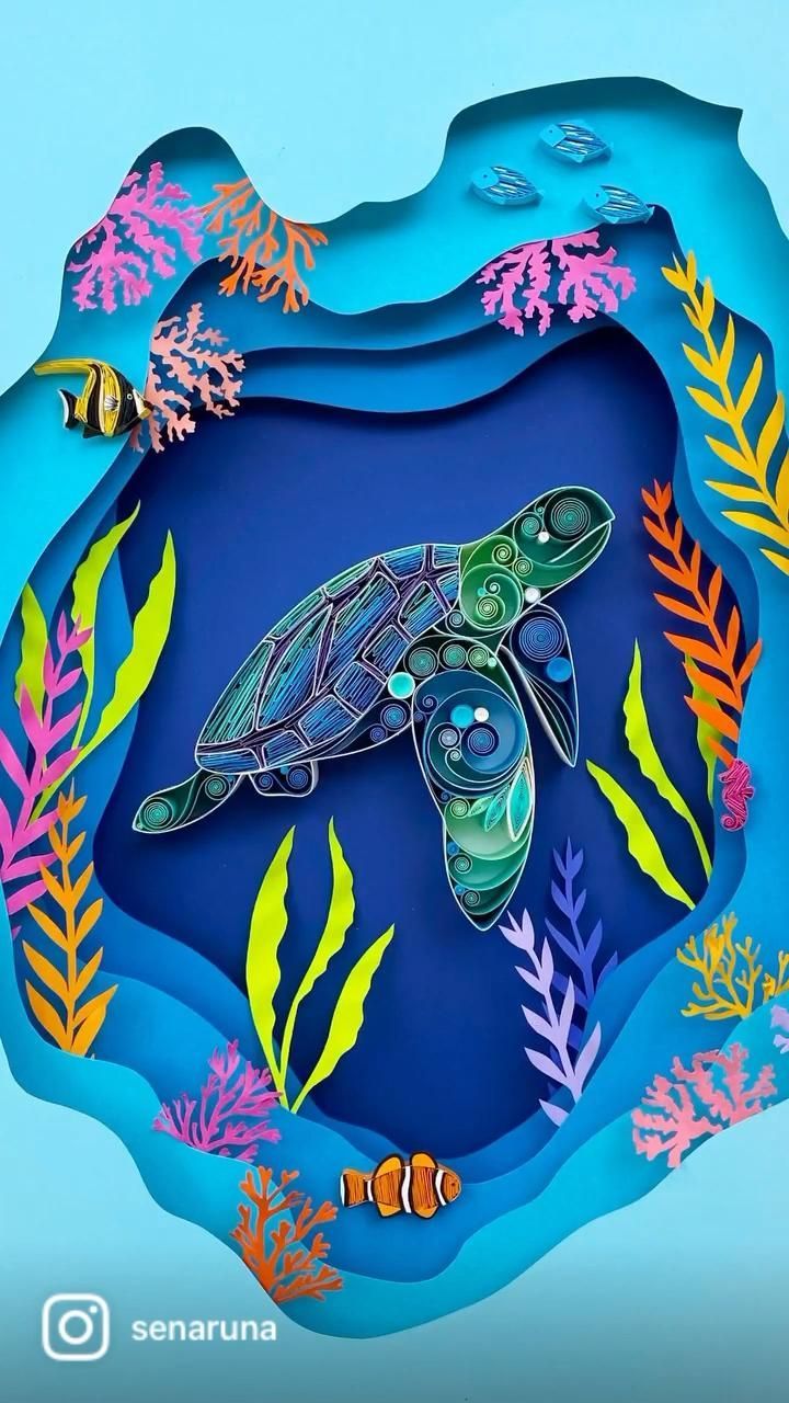 a paper cut out of a turtle swimming in the ocean with corals and seaweed