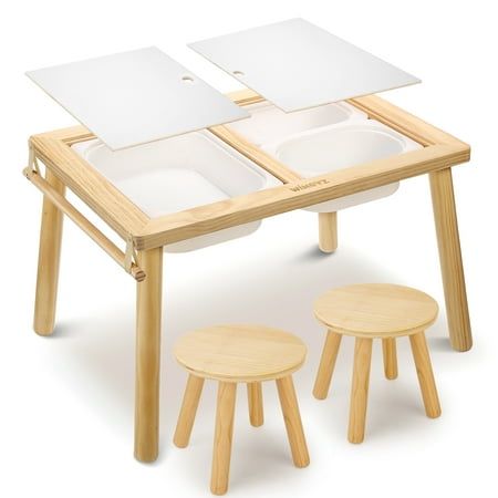 a wooden table with two white plates on it and three small stools underneath the table