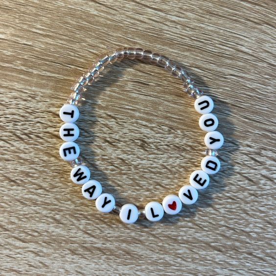 a beaded bracelet with words that say i love you and the word loved on it