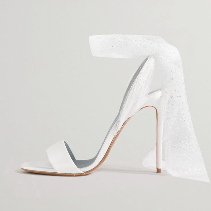 These elegant open-toe sandals are the ideal wedding shoes, bringing a touch of grace and refinement to your special day. Crafted from luxurious satin for a soft sheen, they feature a stiletto heel that elongates your silhouette with style. The open-toe design gives your feet some breathing room, while offering a chic peek of your pedicure. The shoes' secure strap ensures a comfortable fit, allowing you to enjoy your event carefree. Perfect for brides or simply for those desiring a touch of eleg Open Toe Wedding Shoes, Red Carpet Party, Heels Elegant, Breathing Room, Work Formal, Wrap Sandals, Satin Heels, Sandal Heels, Wedding Heels