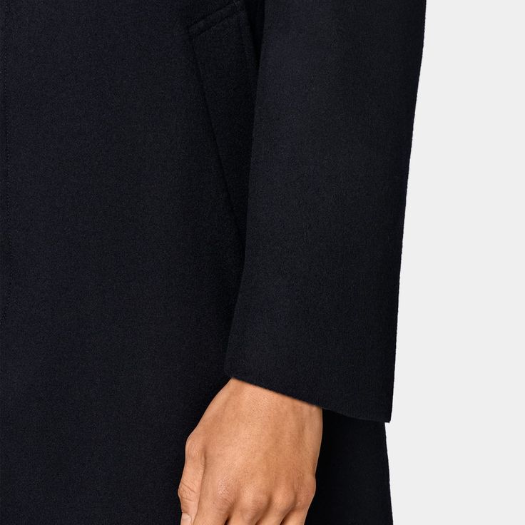 A sleek, minimalist design for a clean
  winter layer, this navy Valencia fit coat features a hidden placket, high-cut
  closure and small noth lapel for a stylishly up-to-date piece that doesn't
  lose traditional elegance. Classic Black Wool Coat With Concealed Fastening, Elegant Fitted Plain Outerwear, Tailored Navy Outerwear With Concealed Placket, Timeless Black Outerwear With Welt Pockets, Modern Black Wool Coat For Business, Business Wool Coat With Concealed Fastening And Lapel Collar, Elegant Navy Outerwear With Welt Pockets, Modern Black Outerwear With Pressed Crease, Classic Peacoat With Lapel Collar And Concealed Placket