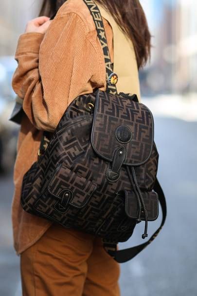 Street style: The Best New Ways To Wear A Backpack. | British Vogue Branded Backpacks, Fendi Backpack, Transitional Fashion, Luxury Backpack, Street Style Bags, Backpack Outfit, Attention Seeking, Fall Trends Outfits, School Things