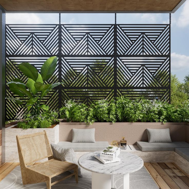 an outdoor living area with white furniture and greenery on the wall, along with wooden flooring