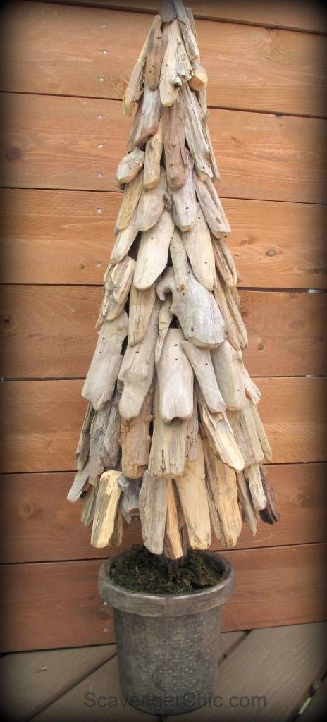 a tree made out of driftwood sitting on top of a potted plant