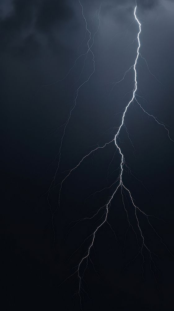 a lightning bolt striking across the sky with dark clouds in the background and lightening behind it