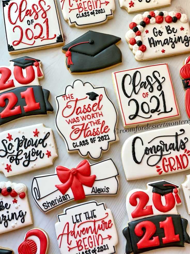 decorated graduation cookies are displayed on a white tablecloth with red and black lettering that reads class of 2013