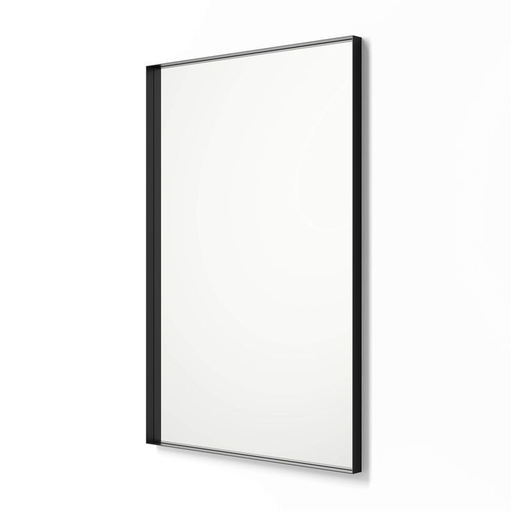 a white wall with a black frame hanging on it's side next to a mirror