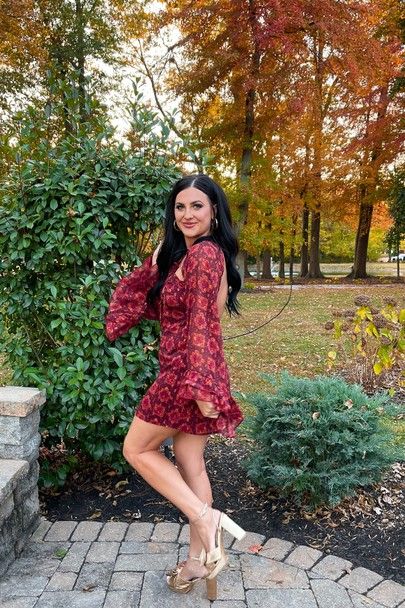 a woman in a red dress posing for the camera