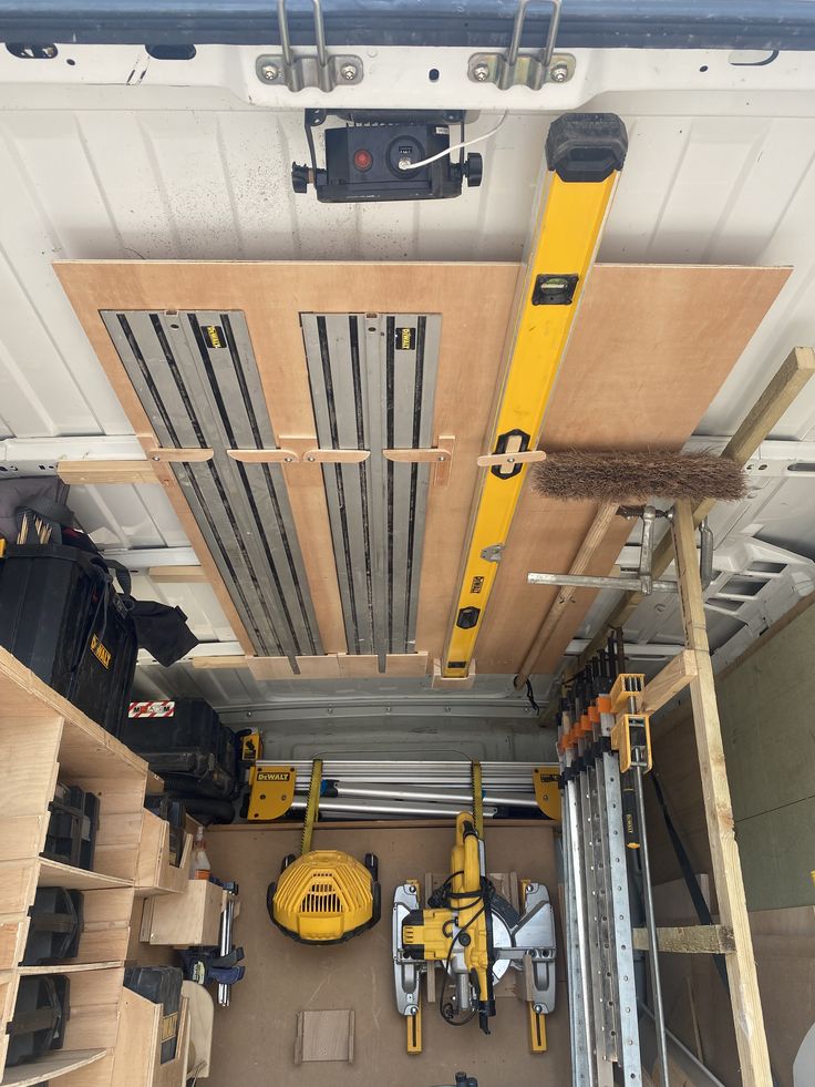 overhead view of construction equipment and tools in storage area with wood planks on the ceiling