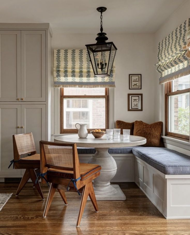 a kitchen with a table, bench and window sill in it's center