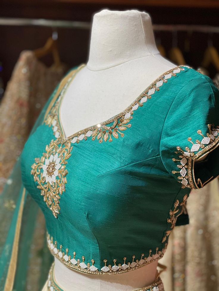 Pearl white plain skirt with waistline pearl embroidery teamed with contrasting pine green zardozi, stone and pearl embroidered blouse and net dupatta. Fabric: Raw Silk This outfit can be customized in multiple colors and specific to client measurements. 90 days of production time is required and are for bulk orders only! Orders are processed in store only! Final fittings/alterations not included. Minimum Order Quantity- 4 pieces Traditional Pearl Embroidered Saree For Festive Occasions, Traditional Floor-length Dupatta With Pearl Embroidery, Traditional Floor-length Anarkali Set With Pearl Embroidery, Traditional Pearl Embroidered Saree For Diwali, Elegant Green Dola Silk Choli, Anarkali Blouse Piece With Pearl Embroidery For Wedding, Anarkali Wedding Blouse Piece With Pearl Embroidery, Anarkali Style Wedding Blouse With Pearl Embroidery, Traditional Blouse Piece With Pearl Embroidery