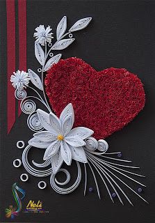 a red and white heart with flowers on black paper, surrounded by silver metal filigrees