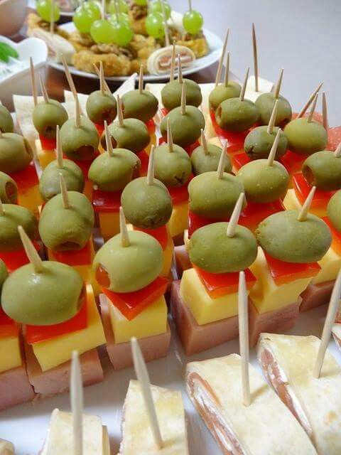 many small appetizers are arranged on sticks