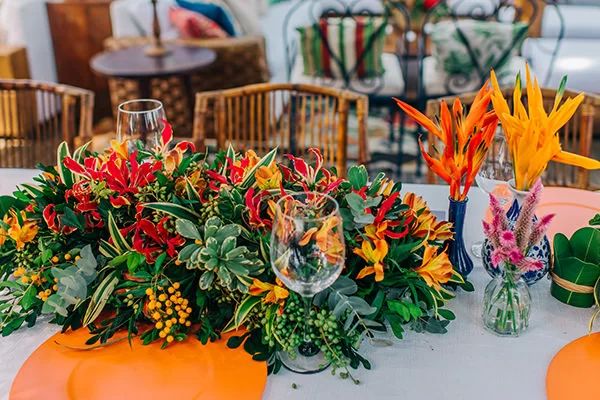 the table is set with colorful flowers and wine glasses for an elegant dinner or party