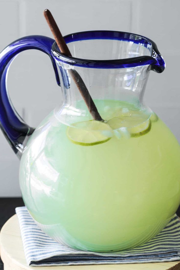 a pitcher filled with liquid sitting on top of a table