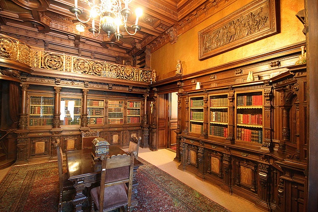 an old library with many bookshelves and chandelier