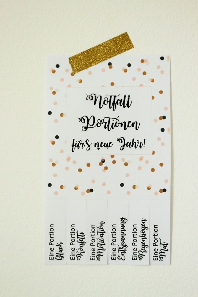 a white paper with black and gold confetti on it