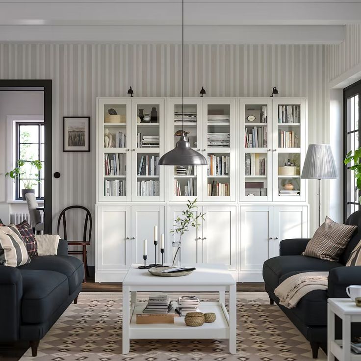 a living room with two couches, a coffee table and some bookshelves