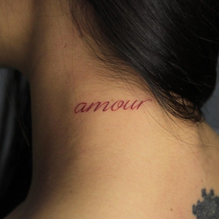 a woman's neck with the word annour written on it in cursive font