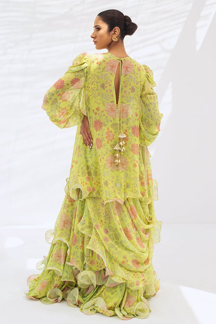 Leena (A) – Sania Maskatiya International Green Ruffled Sharara With Traditional Drape, Green Sharara With Ruffles And Traditional Drape, Bollywood Floor-length Ruffled Dress, Bollywood Style Floor-length Ruffled Dress, Pista Green Anarkali Dress With Floral Print, Anarkali Floor-length Sets With Ruffles, Green Traditional Drape Dress For Spring, Festive Pista Green Dress With Floral Print, Green Spring Dress With Traditional Drape