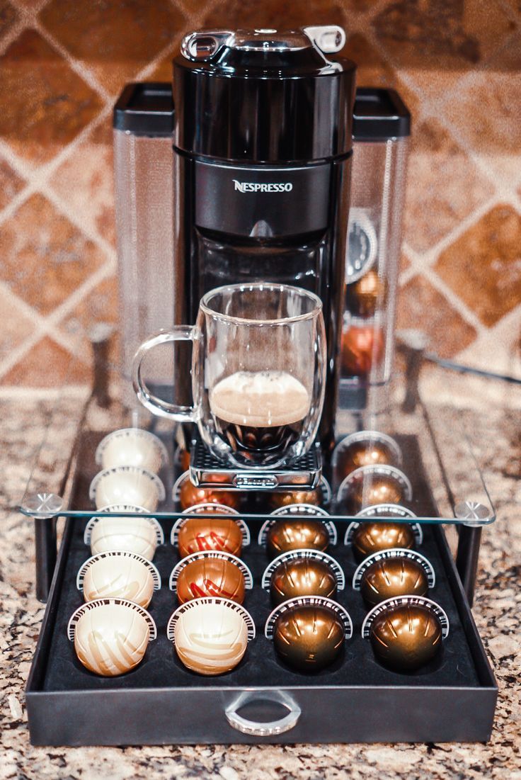 an assortment of coffee and espresso drinks in front of a coffee maker on a granite countertop