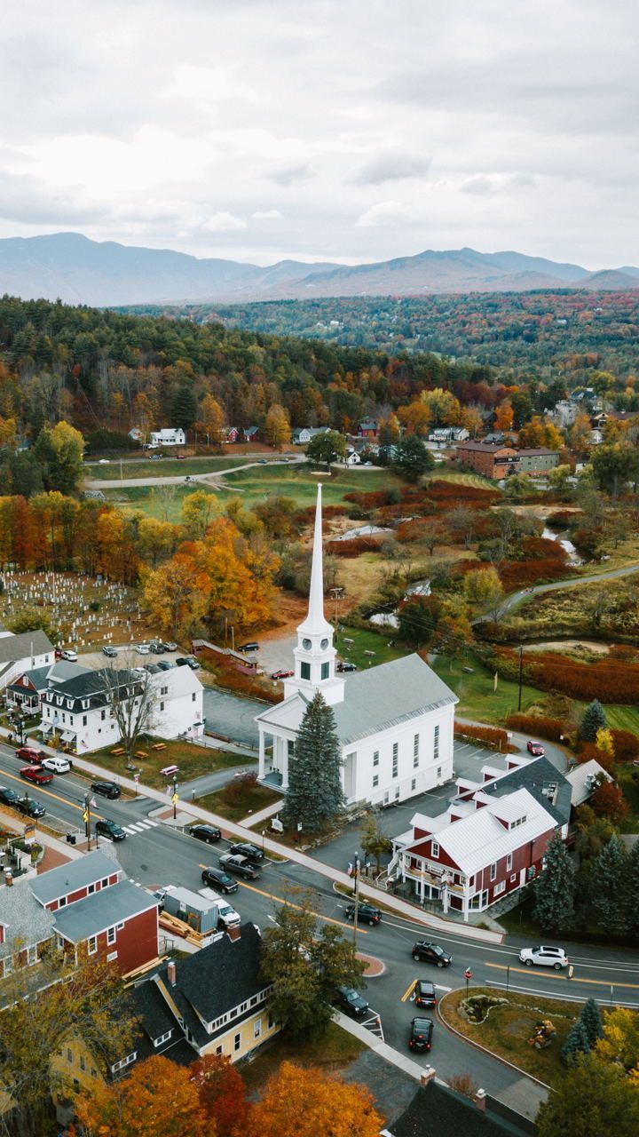 an aerial view of a small town in the fall