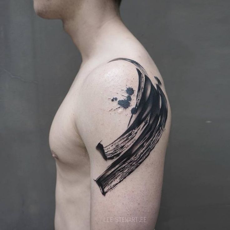 a man with a black ink wave tattoo on his arm