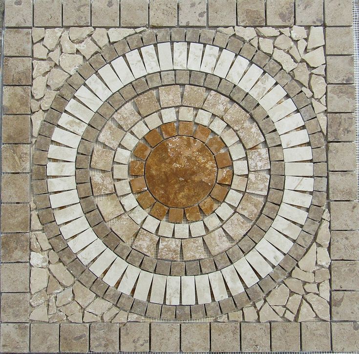 a circular pattern made out of white and brown bricks