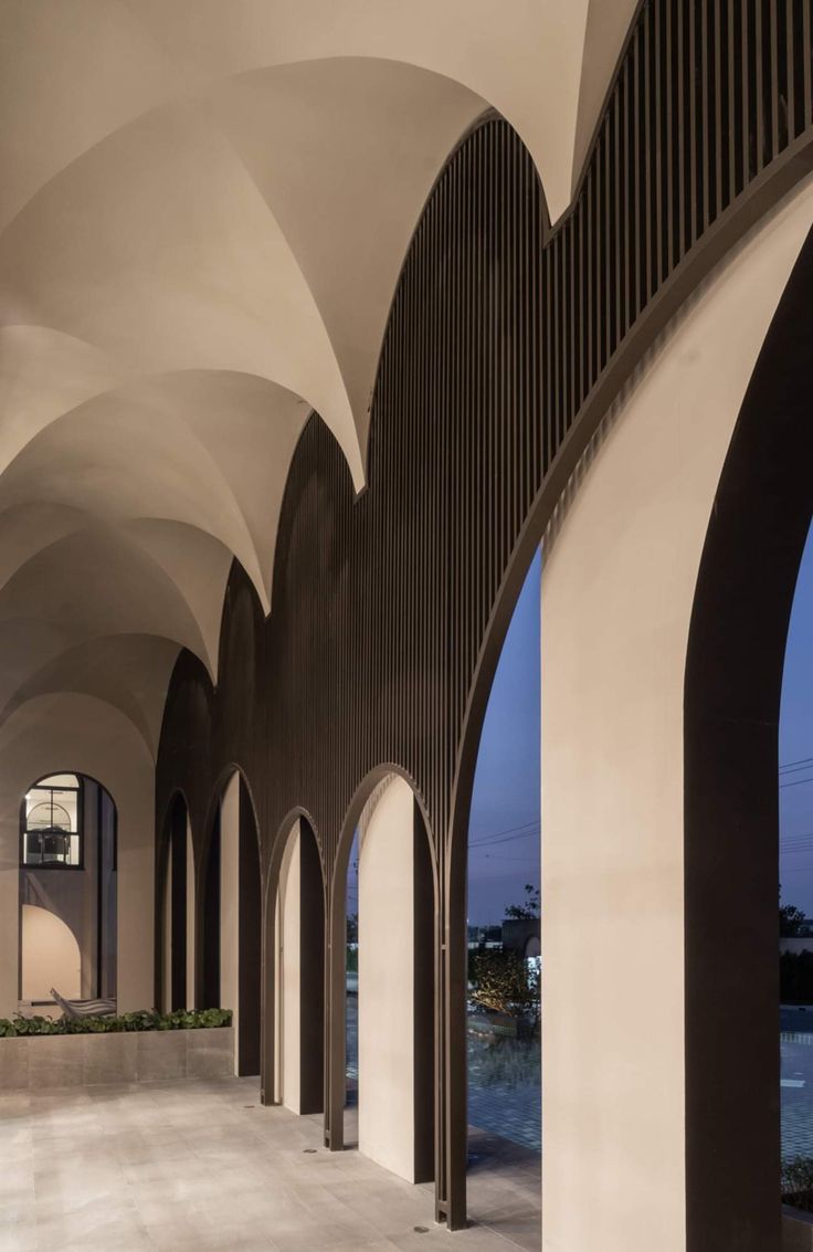 an empty room with arches and windows