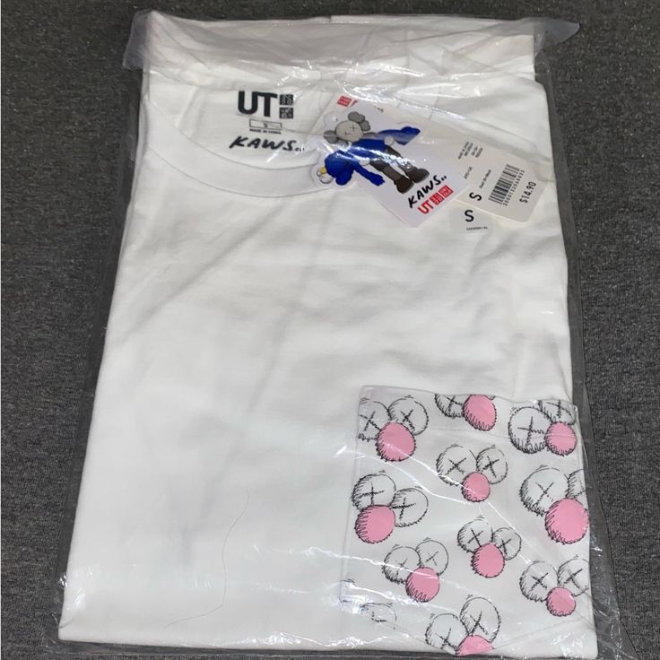 *Nwt* Kaws X Uniqlo Collaboration T- Shirt (Pocket) Size: Small **Purchased From Uniqlo Drop** - Authenticity Guaranteed - Item Comes Brand New And In Original Packaging - No Returns Refunds Or Exchanges On Final Sale Items Thanks For Looking As Always And Feel Free To Message With Any Questions! White Short Sleeve Tops With Patch Pockets, White Short Sleeve Shirt With Patch Pockets, White Relaxed Fit Top With Patch Pockets, White Tops With Patch Pockets In Relaxed Fit, Relaxed White Tops With Patch Pockets, White Cotton Tops With Pockets, White Casual T-shirt With Side Pockets, White Crew Neck Top With Side Pockets, White Crew Neck T-shirt With Pockets