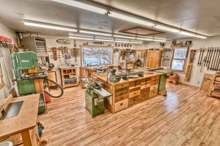 the shop is full of woodworking tools and workbenches, all in one area