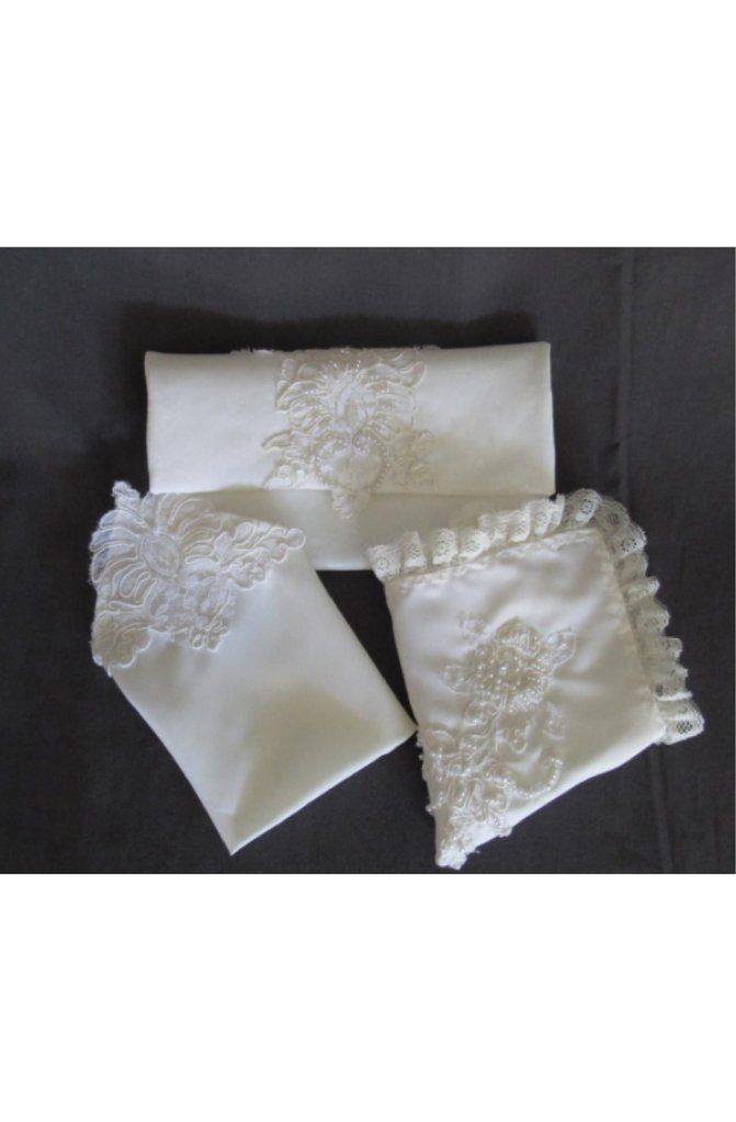 three pieces of white cloth with embroidered flowers on the bottom and one piece has ruffled edges