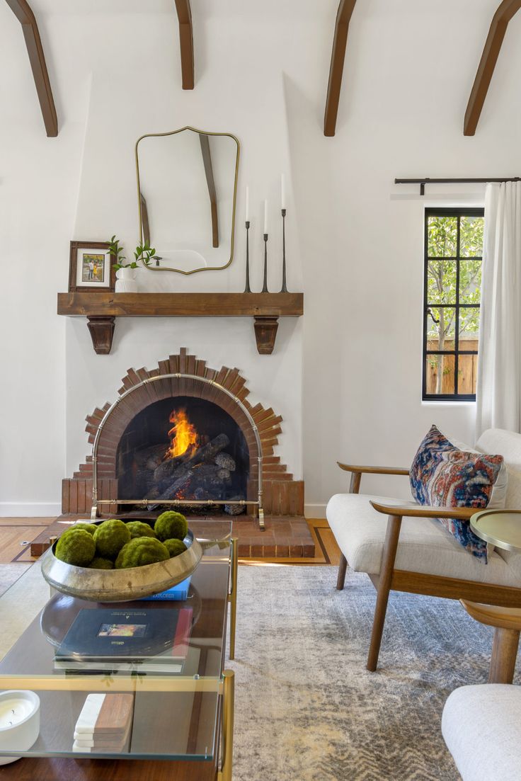 a living room filled with furniture and a fire place in the middle of a room