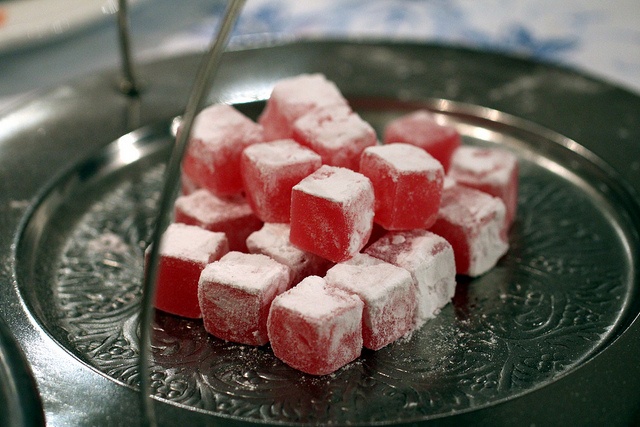 sugar cubes sit on top of a metal plate