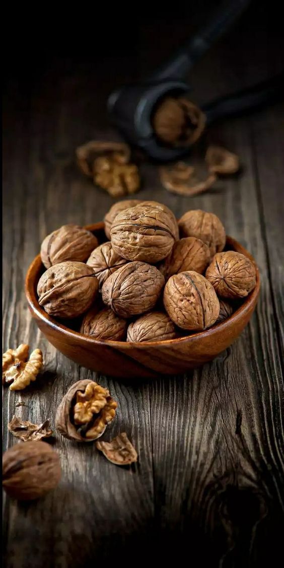 walnuts in a wooden bowl on a table