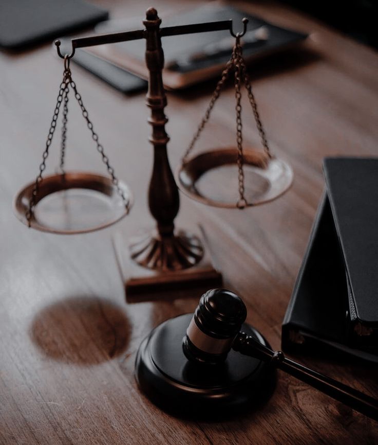 a judge's gaven sitting on top of a wooden table next to a laptop computer